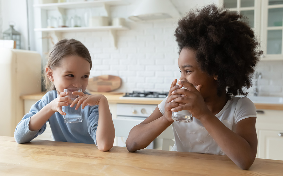 Two children drinking water