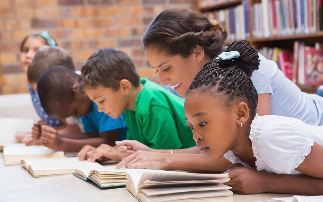 Children and teacher reading 