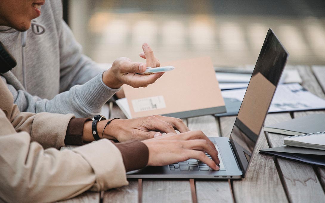 Two students looking at a laptop