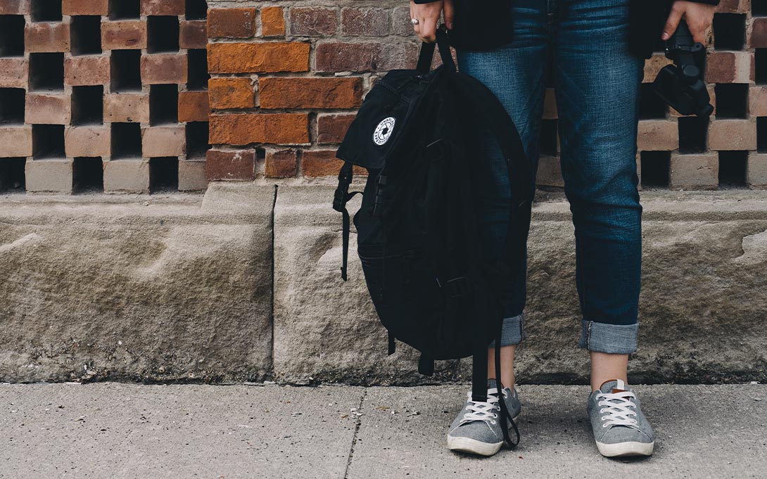 Student holding a backpack