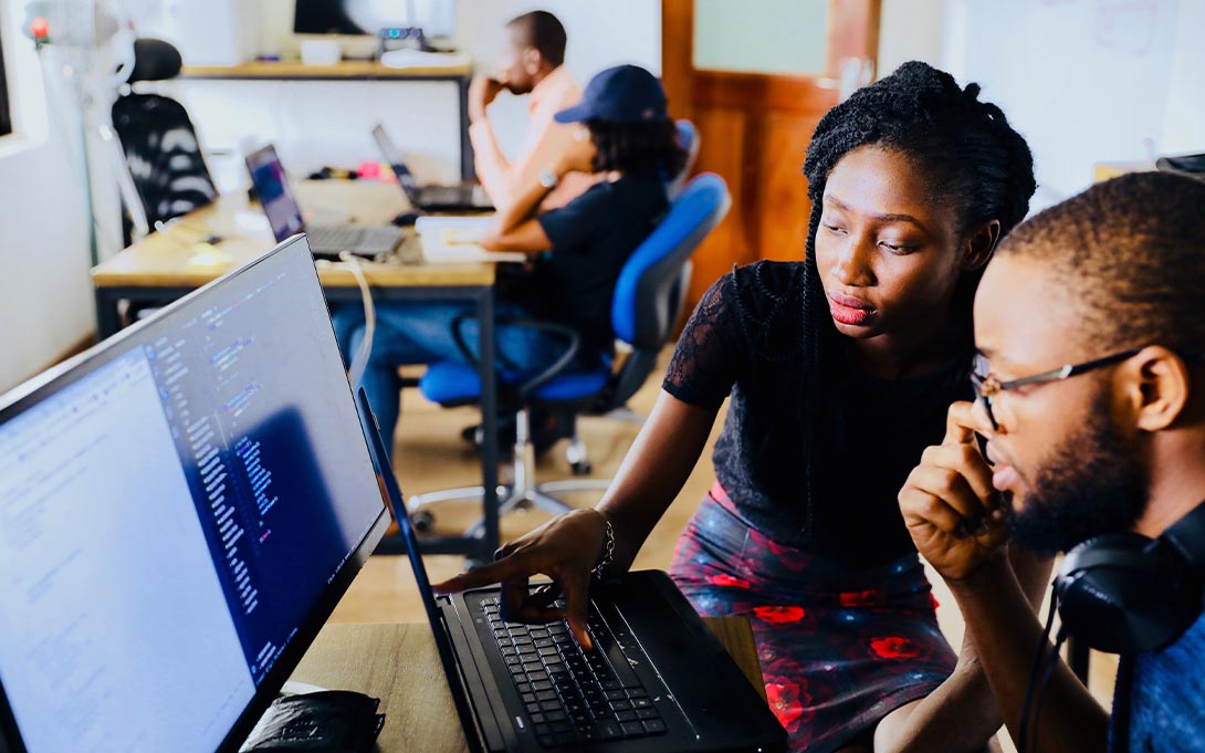 Two students collaborating on a computer assignment