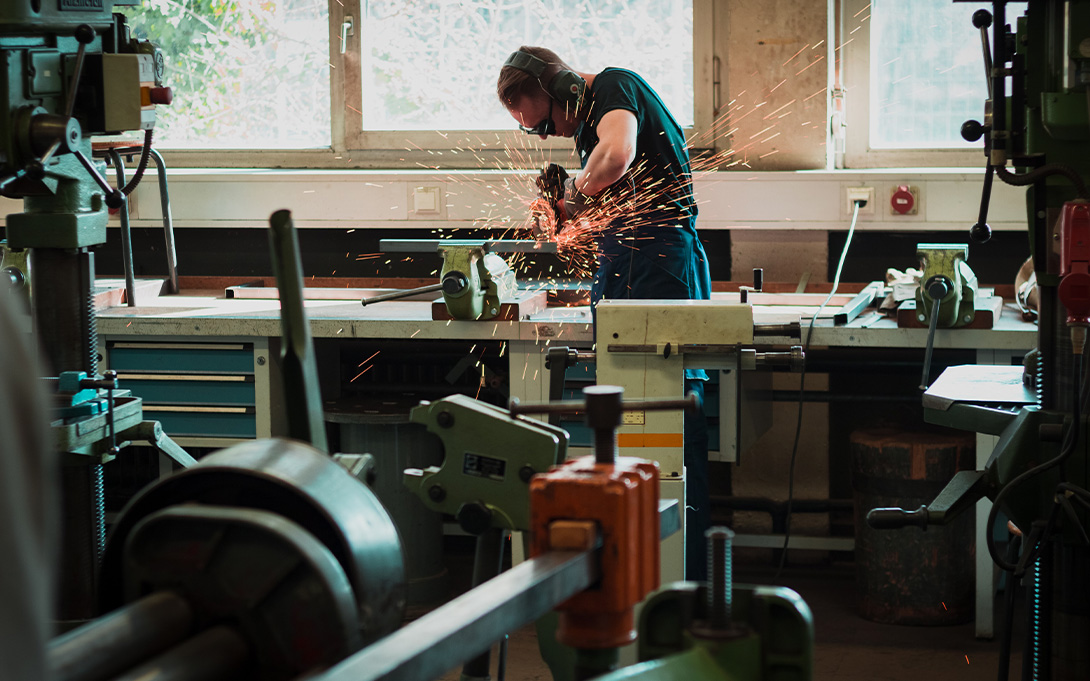 Student completing a metalworking project