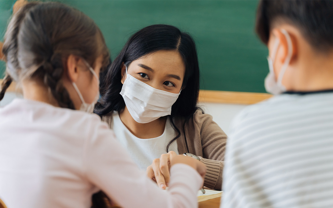 Teacher and students in class wearing masks