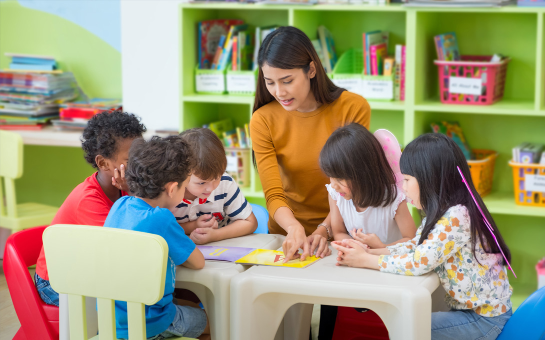 Teacher with children in kindergarten classroom