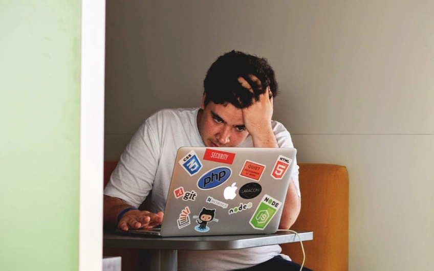 Fatigued student working on a laptop