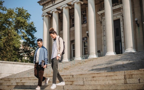 Two students walking on a college campus
