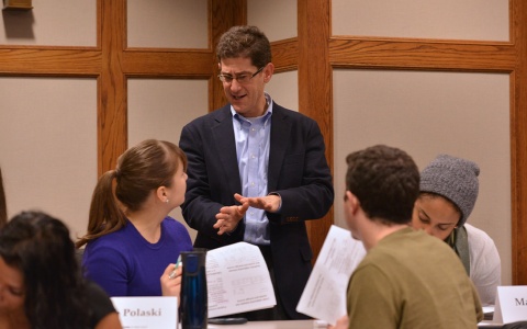 Brian Jacob explaining a concept to a student in class